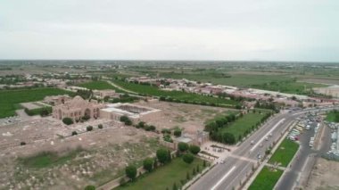 Panorama of Bahouddin Naqshband memorial complex near Bukhara filmed by drone cam on a cloudy day. Green gardens, highway and parking zone are also in the frame