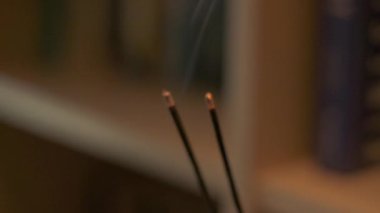 Burning aromatic sticks for meditation while doing yoga. Slow motion