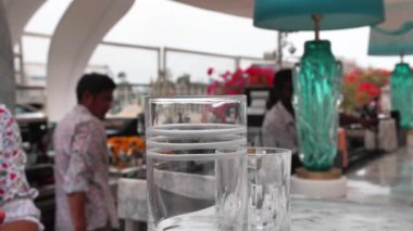 Barman is making cocktail with ice and coctail shaker at club. Part of coctail making series. Slow motion shooting