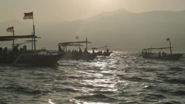 Asian white double-outrigger boats in blue waters. Windy weather