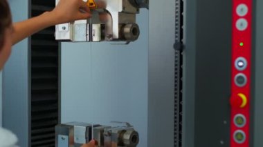 Polymer thread for plastic sack bags is installed to strength test machine, slow motion