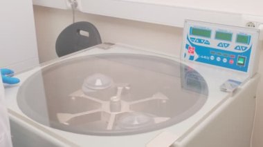 Refrigerated vaccine centrifugation in laboratory, slow motion