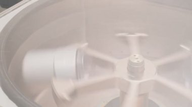 Refrigerated vaccine centrifugation in laboratory, slow motion