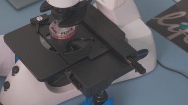 A sample of a substance is observed under a microscope in a laboratory, slow motion