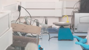 Substance sample for vaccine is shaked in laboratory, slow motion