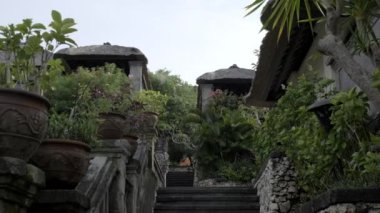 Stone staircase in a beautiful tropical cottage village. Slow motion.