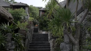 Stone staircase in a beautiful tropical cottage village. Slow motion.