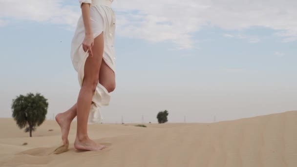 Brunette Barefoot White Dress Fluttering Wind Walks Desert Sand Slow — Video