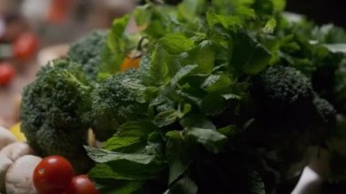 Fresh greens and veggies on the table close up slow motion