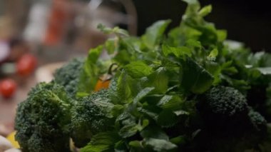 Fresh greens and veggies on the table close up slow motion