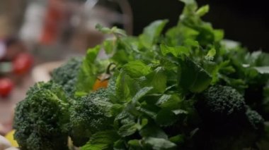 Fresh greens and veggies on the table close up slow motion