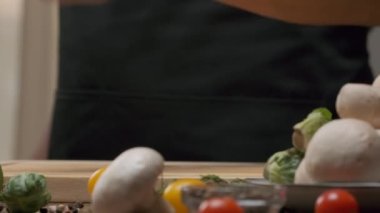 Professional chef prepares and cuts red bell pepper. Close up slow motion