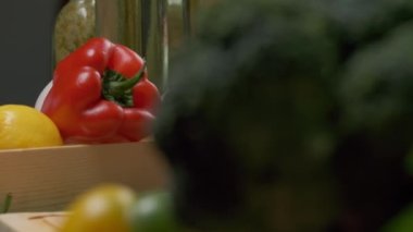 Professional chef prepares and cuts red bell pepper. Close up slow motion
