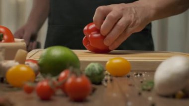 Professional chef prepares and cuts red bell pepper. Close up slow motion