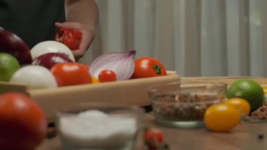 Professional chef prepares and cuts red bell pepper. Close up slow motion