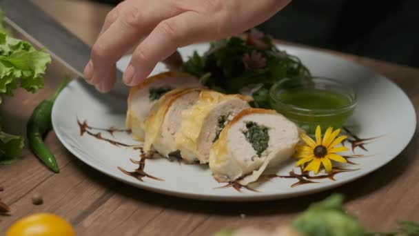 Serving Chicken Roll Spinach Greens Green Oil Plate Close Hands — Stock Video