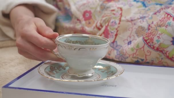 Close White Porcelain Cup Gold Ornaments Taken Saucer Woman Laying — Wideo stockowe