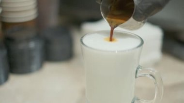 Barista makes coffee on a coffee machine, slow motion close-up.
