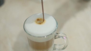 Barista makes coffee on a coffee machine, slow motion close-up.