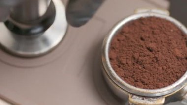Barista makes coffee on a coffee machine, slow motion close-up.