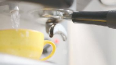 Barista makes coffee on a coffee machine, slow motion close-up.