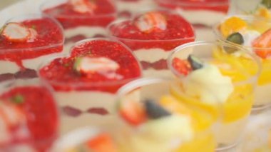 Slow motion close-up shooting of sweet berry and fruit brand desserts