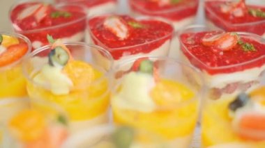 Slow motion close-up shooting of sweet berry and fruit brand desserts