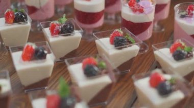 Slow motion close-up shooting of sweet berry and fruit brand desserts