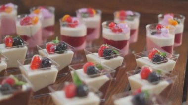 Slow motion close-up shooting of sweet berry and fruit brand desserts