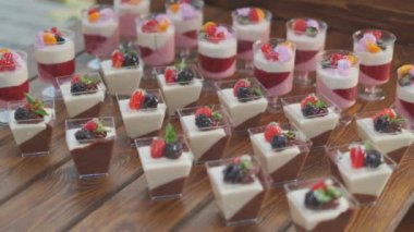 Slow motion close-up shooting of sweet berry and fruit brand desserts