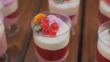 Slow motion close-up shooting of sweet berry and fruit brand desserts