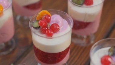 Slow motion close-up shooting of sweet berry and fruit brand desserts