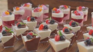 Slow motion close-up shooting of sweet berry and fruit brand desserts