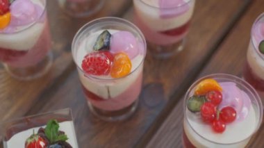 Slow motion close-up shooting of sweet berry and fruit brand desserts