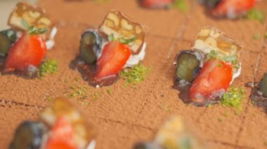 Slow motion close-up shooting of sweet berry and fruit brand desserts
