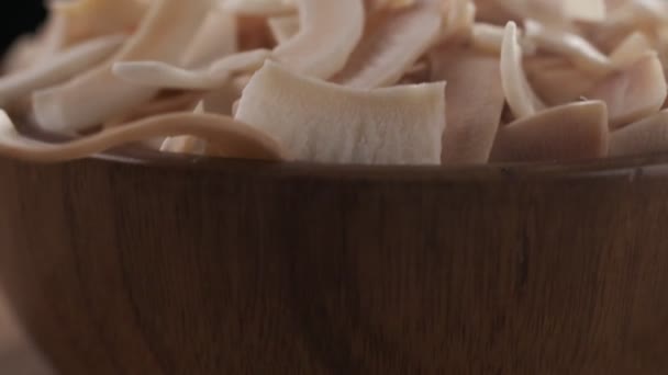 Coconut Chips Falling Wooden Bowl Close Slow Motion — Stockvideo