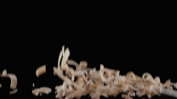 Flying Coconut Chips Black Background Slow Motion — Stock video
