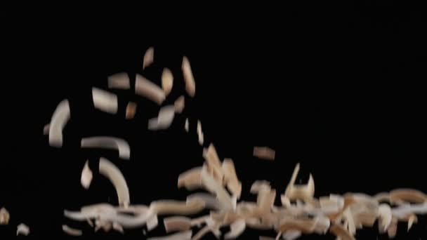 Flying Coconut Chips Black Background Slow Motion — Stock video