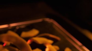 Coconut chips on a dark table close-up. Black background, slow motion.