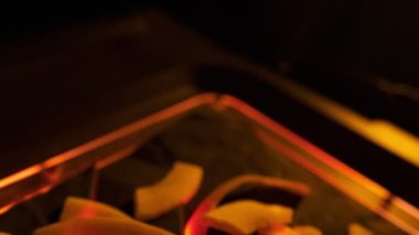 Coconut chips on a dark table close-up. Black background, slow motion.