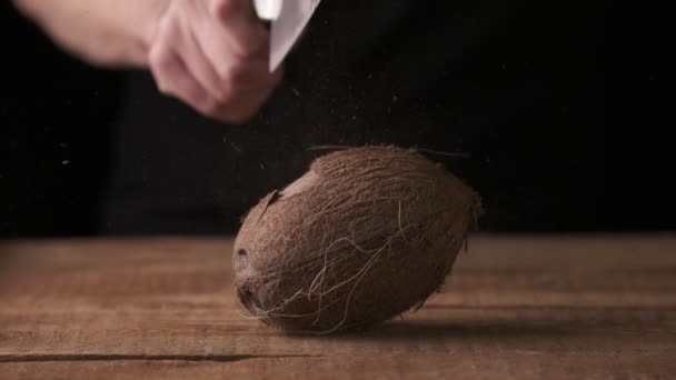 Man Tries Chop Coconut Table Black Background Slow Motion — Wideo stockowe