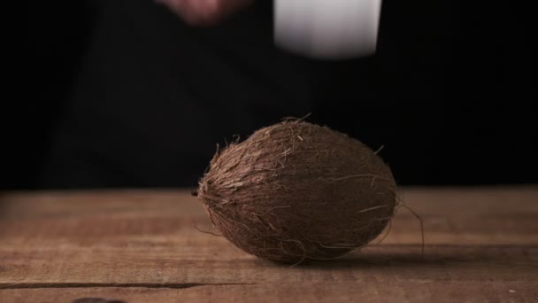 Man Tries Chop Coconut Table Black Background Slow Motion — 图库视频影像