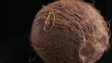 Coconut spinning on a black background, slow motion