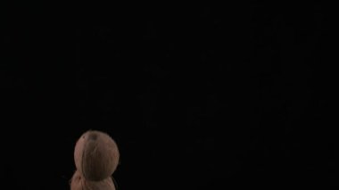 Flying up coconuts on the black background, slow motion