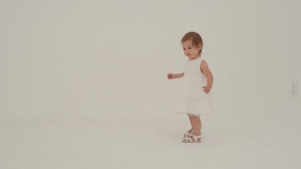 Little Girl Dress Playing White Carpet Slow Motion — Stok video