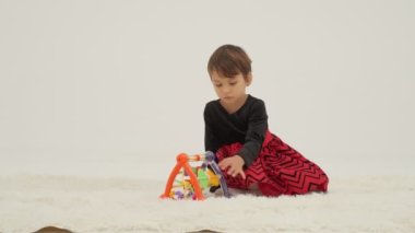 Little short hair girl plays toys with little sister wearing diaper
