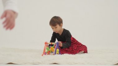 Little short hair girl plays toys with little sister wearing diaper