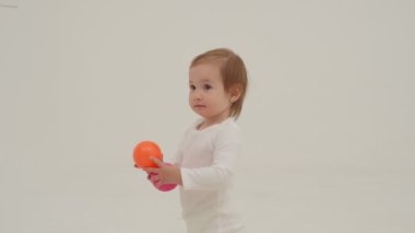 Little short hair girl plays toys with little sister wearing diaper