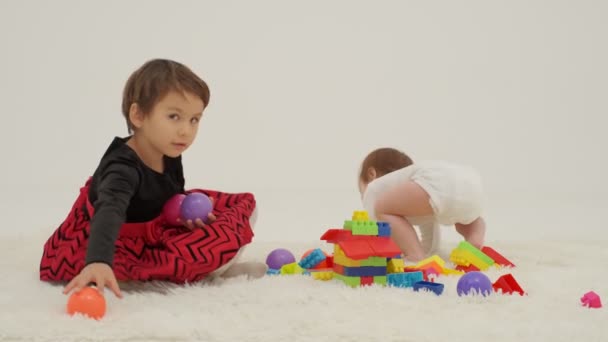 Little Short Hair Girl Plays Toys Little Sister Wearing Diaper — Stockvideo