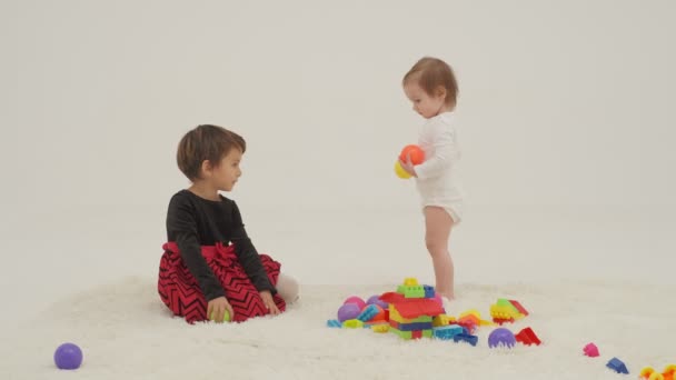 Little Short Hair Girl Plays Toys Little Sister Wearing Diaper — Vídeo de stock